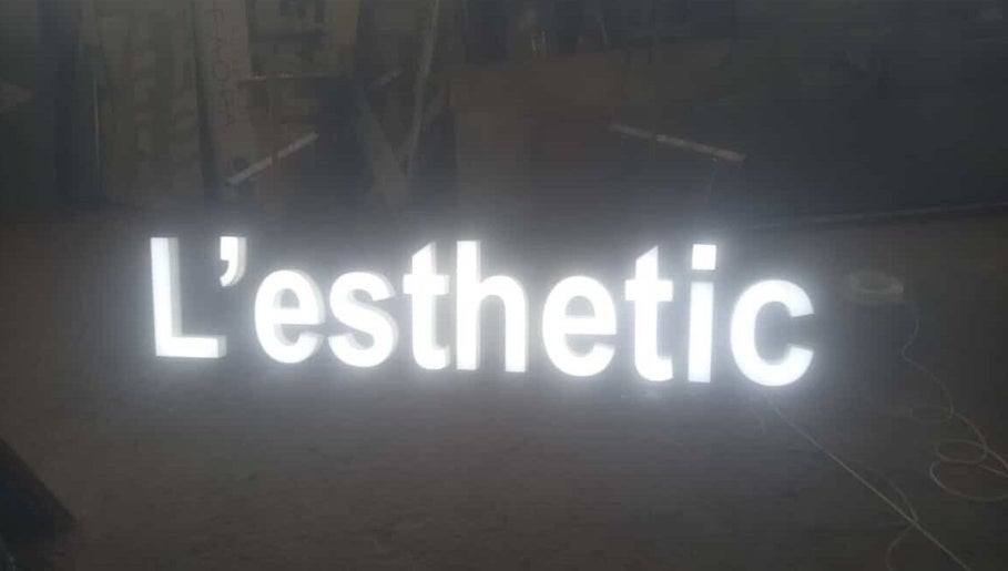 Illuminated L'esthetic sign at Jabal Lubnan, LB. Showcasing modern beauty and wellness.