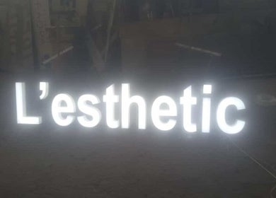Illuminated L'esthetic sign at Jabal Lubnan, LB. Showcasing modern beauty and wellness.