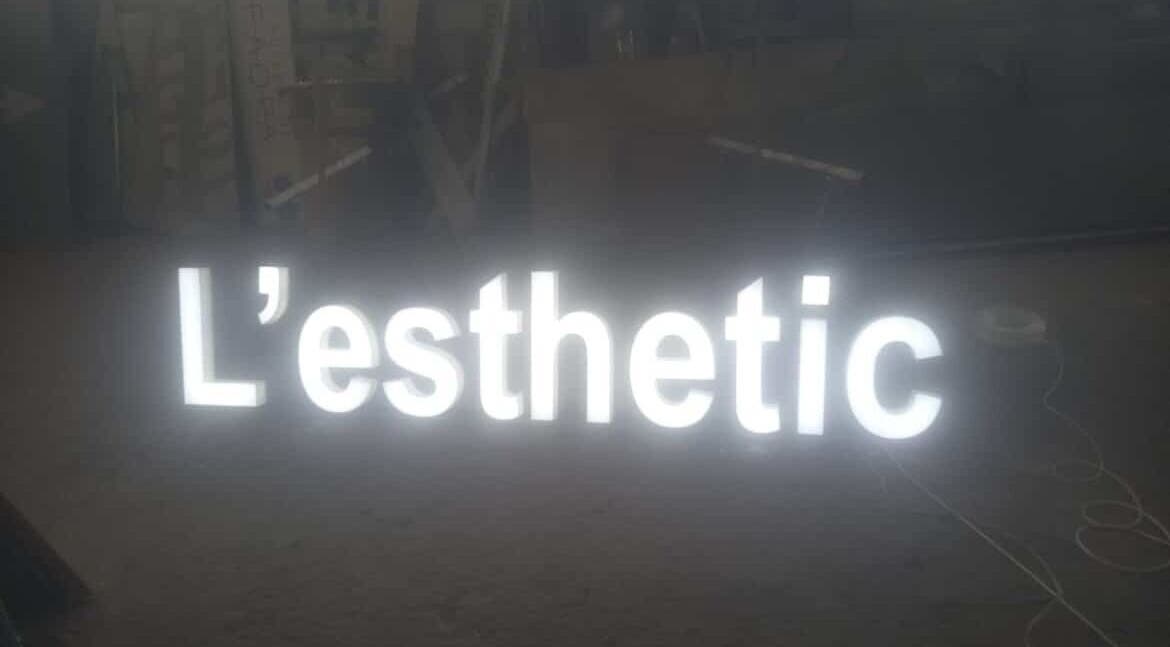 Illuminated L'esthetic sign at Jabal Lubnan, LB. Showcasing modern beauty and wellness.