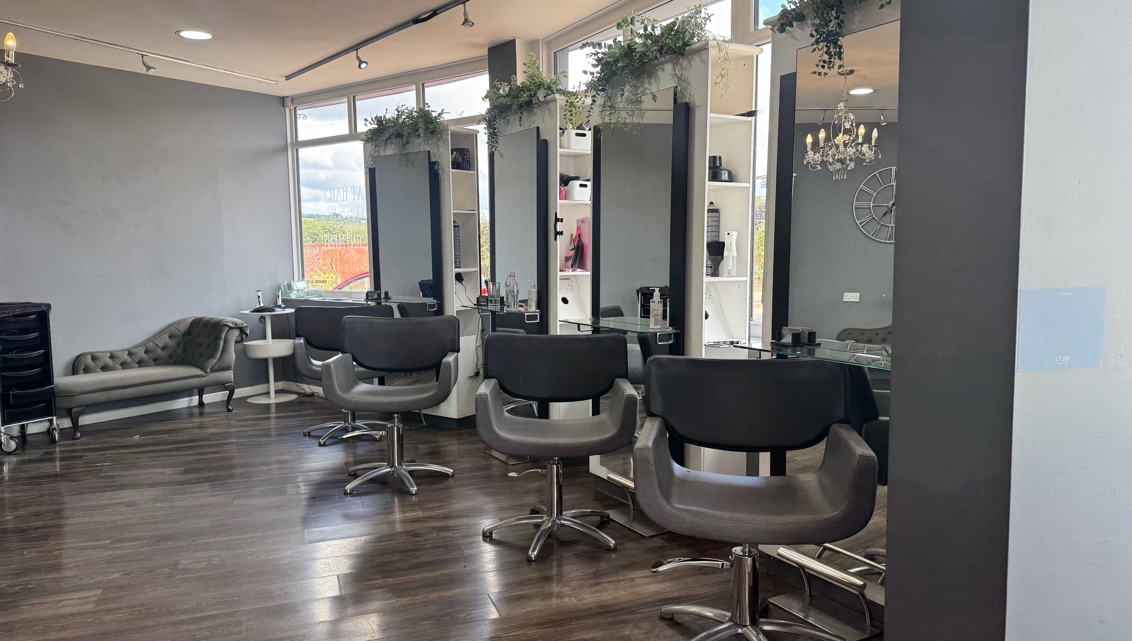 Modern salon interior at Nutters, Exeter, England, GB with stylish chairs and soft lighting.