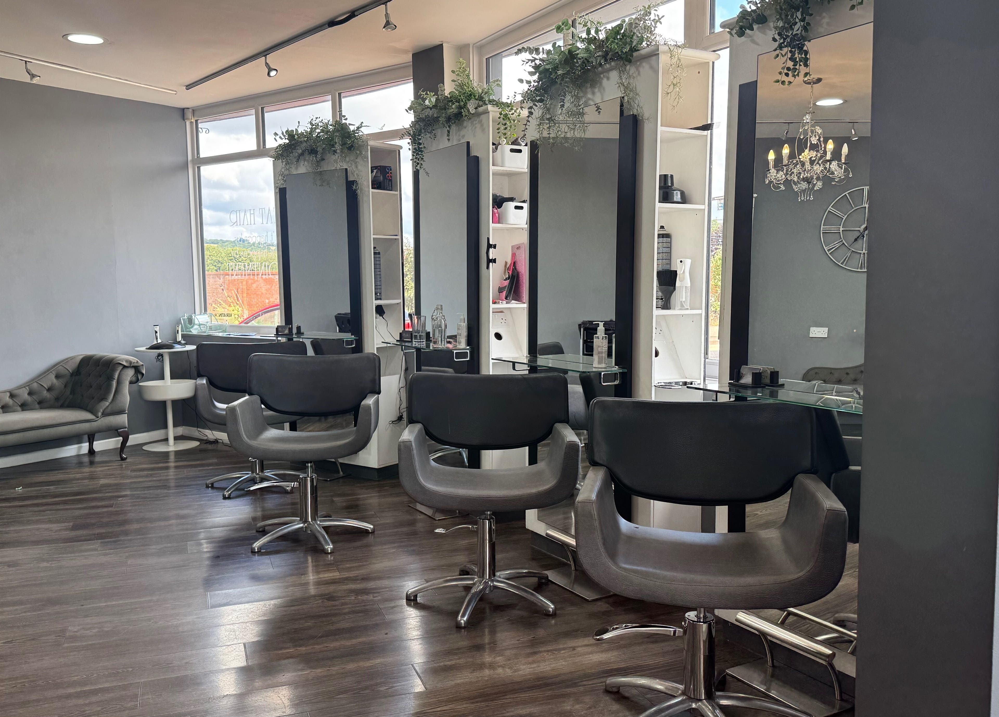Modern salon interior at Nutters, Exeter, England, GB with stylish chairs and soft lighting.
