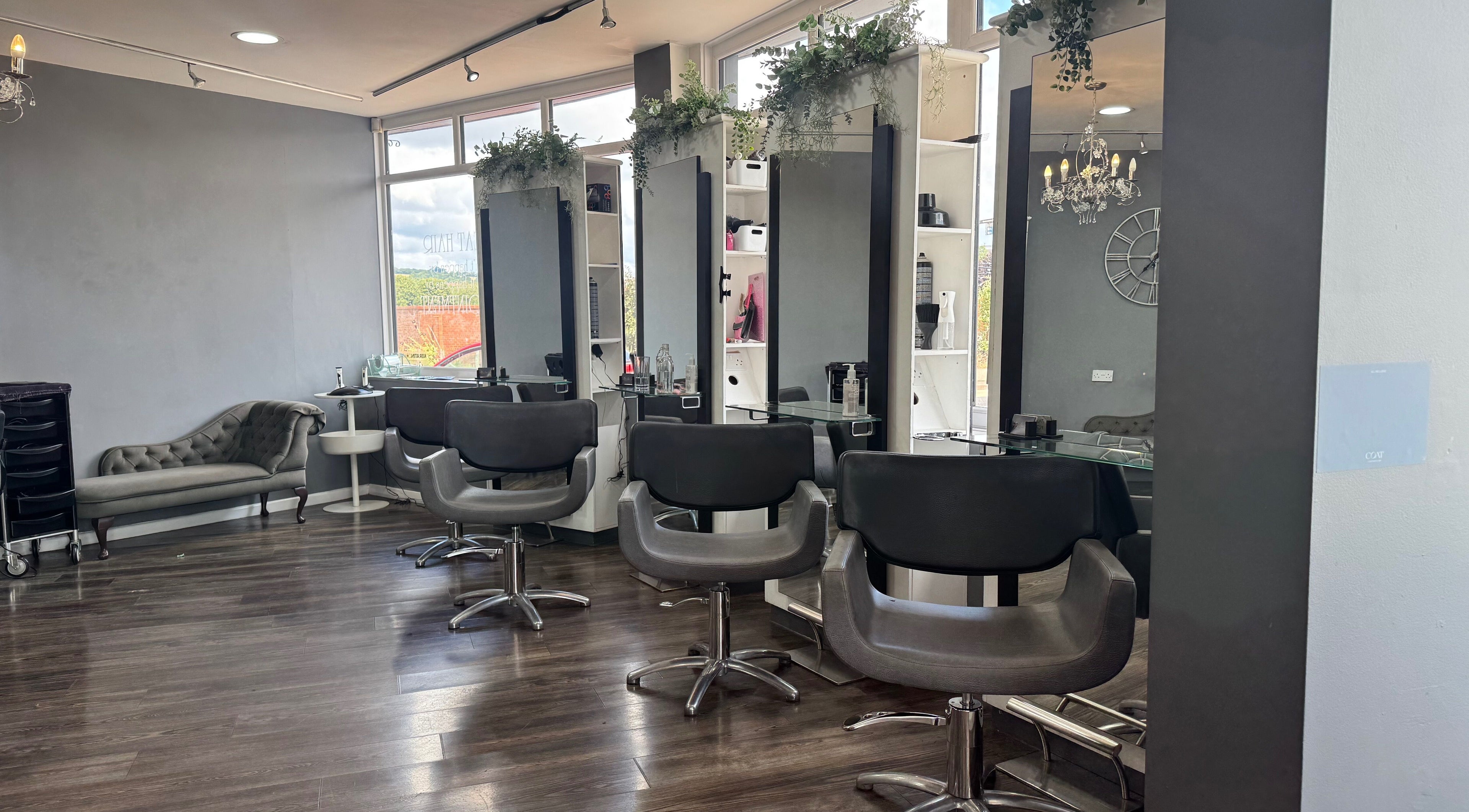 Modern salon interior at Nutters, Exeter, England, GB with stylish chairs and soft lighting.
