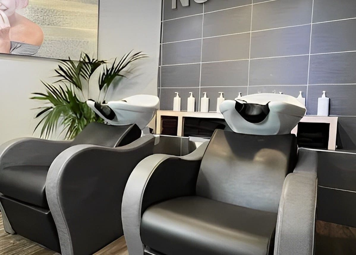 Modern salon wash station at Nutters in Exeter, England, GB with sleek design and plant decor.