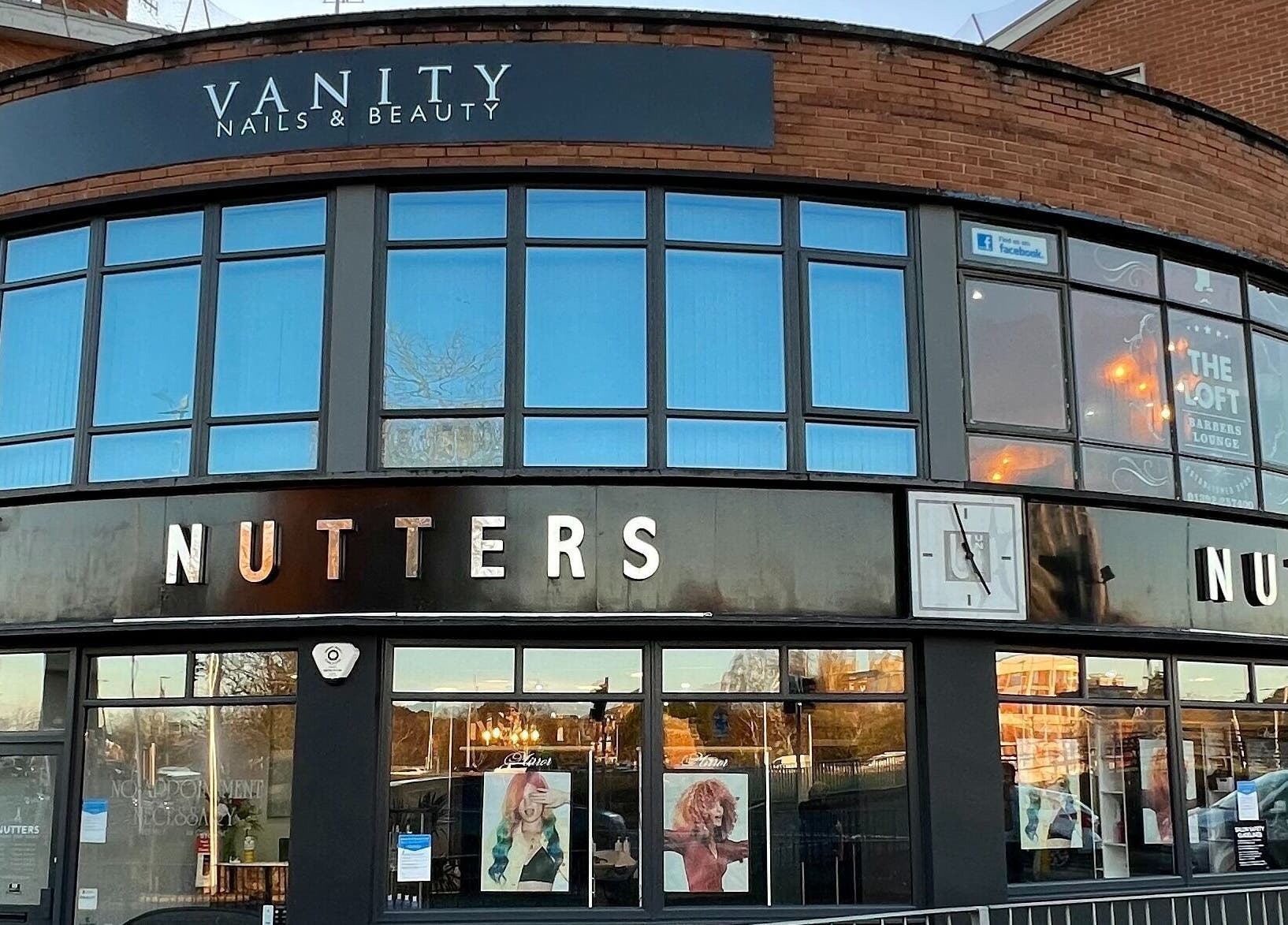 Exterior view of Nutters beauty salon in Exeter, England, GB, showcasing modern design and stylish windows.