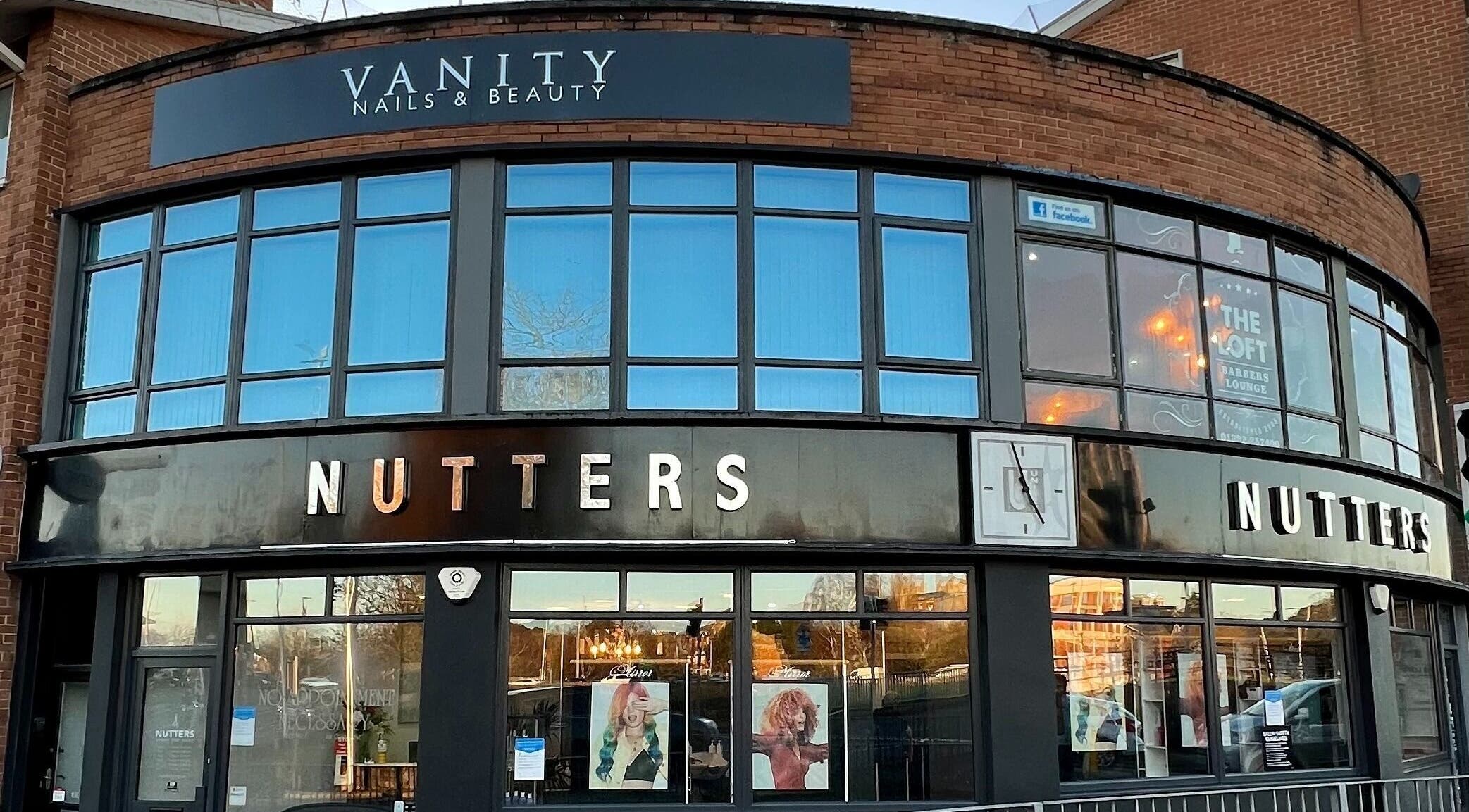 Exterior view of Nutters beauty salon in Exeter, England, GB, showcasing modern design and stylish windows.