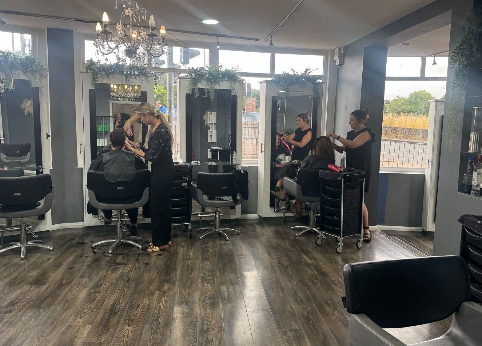 Stylists at Nutters, Exeter, England, GB, working with clients in a chic and modern salon setting.