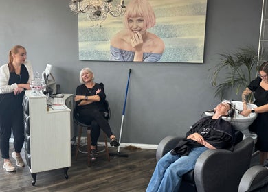 Nutters salon in Exeter, England, GB with staff and customer enjoying hair service.