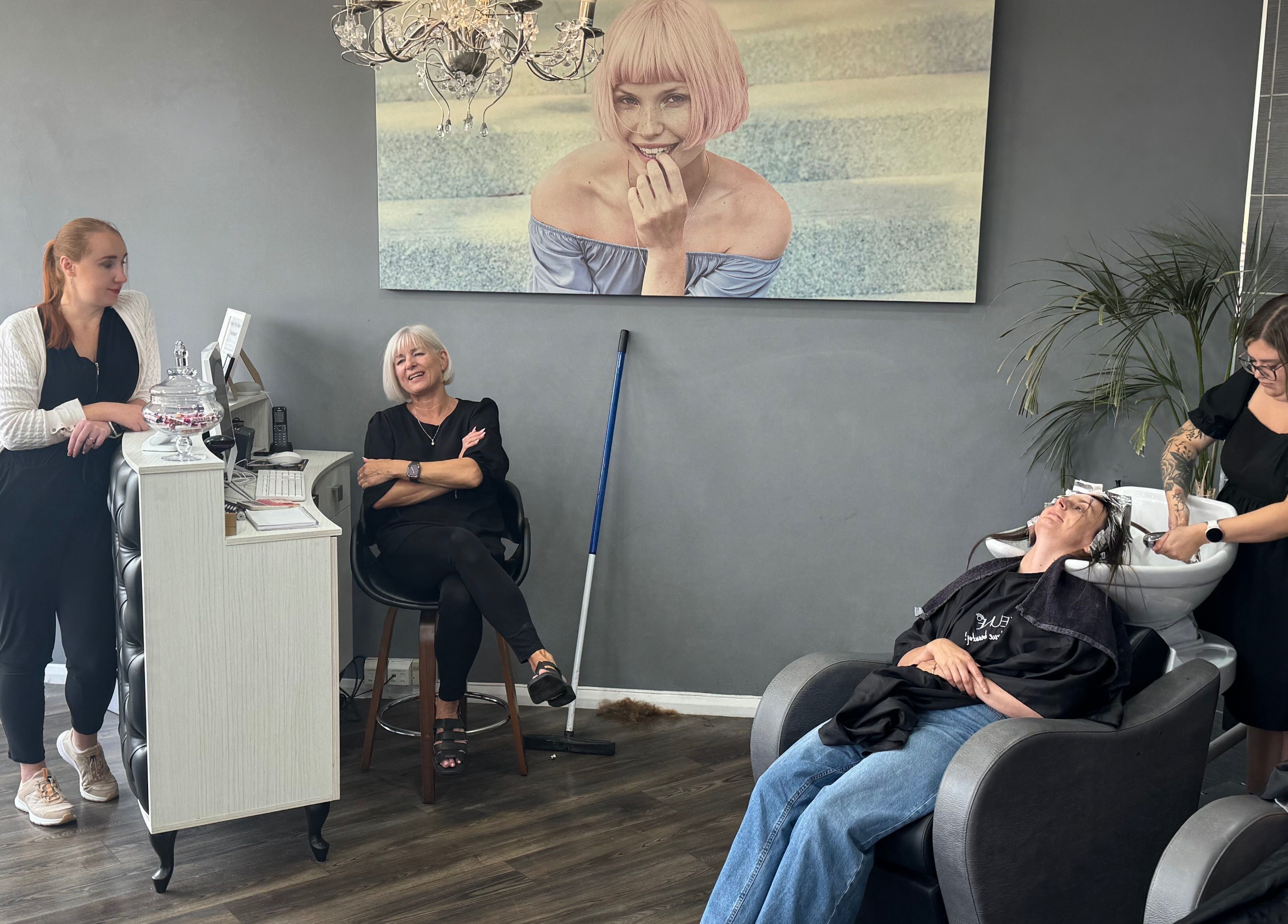 Nutters salon in Exeter, England, GB with staff and customer enjoying hair service.