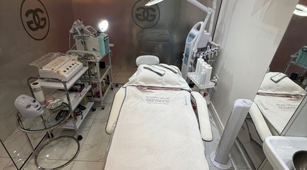 Relaxing treatment room at Aura Beauty in London, England, GB, showcasing skincare equipment and a cozy therapy bed.