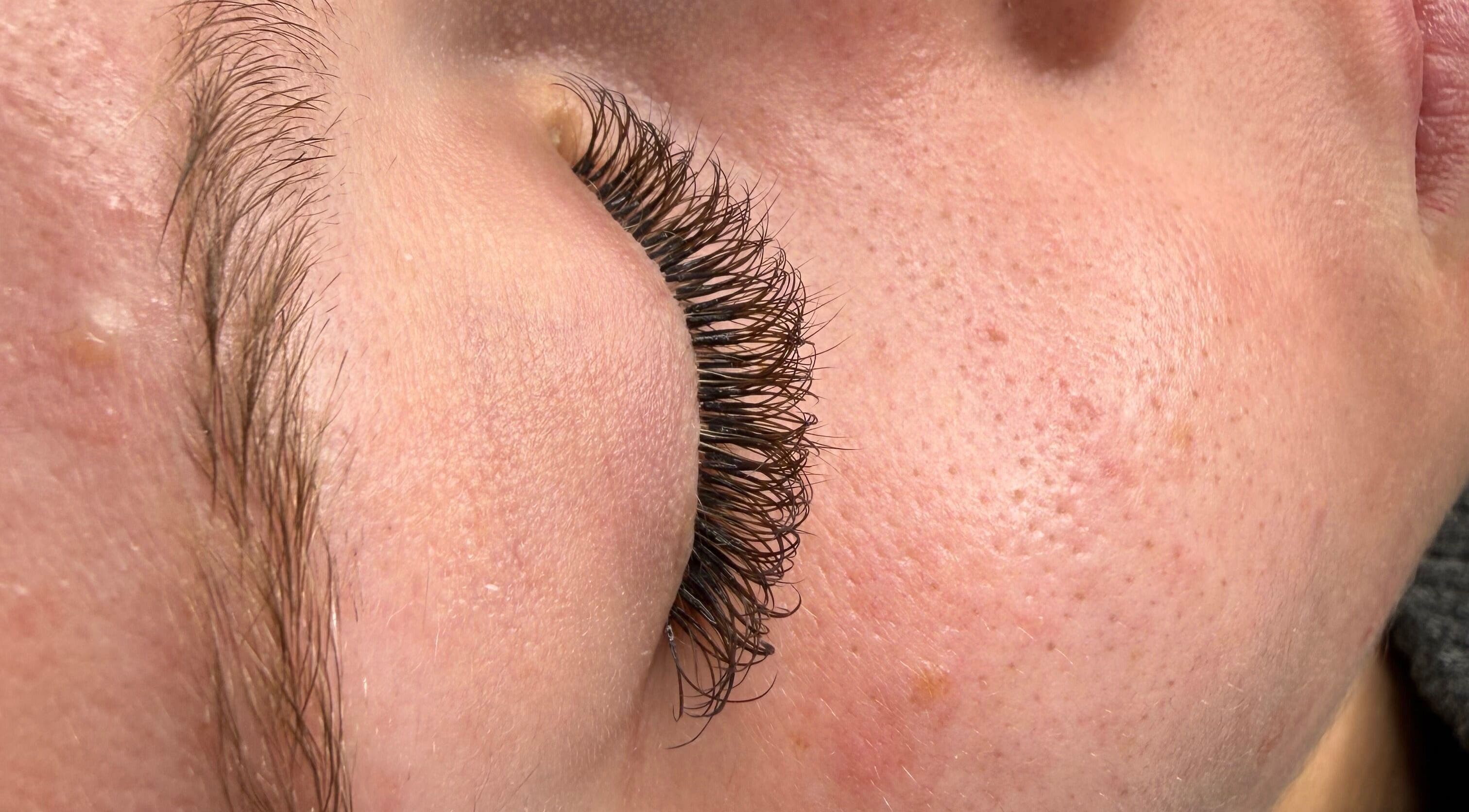Close-up of a client's eye with lush eyelash extensions at Kora beauty studio, Calgary, Alberta, CA.