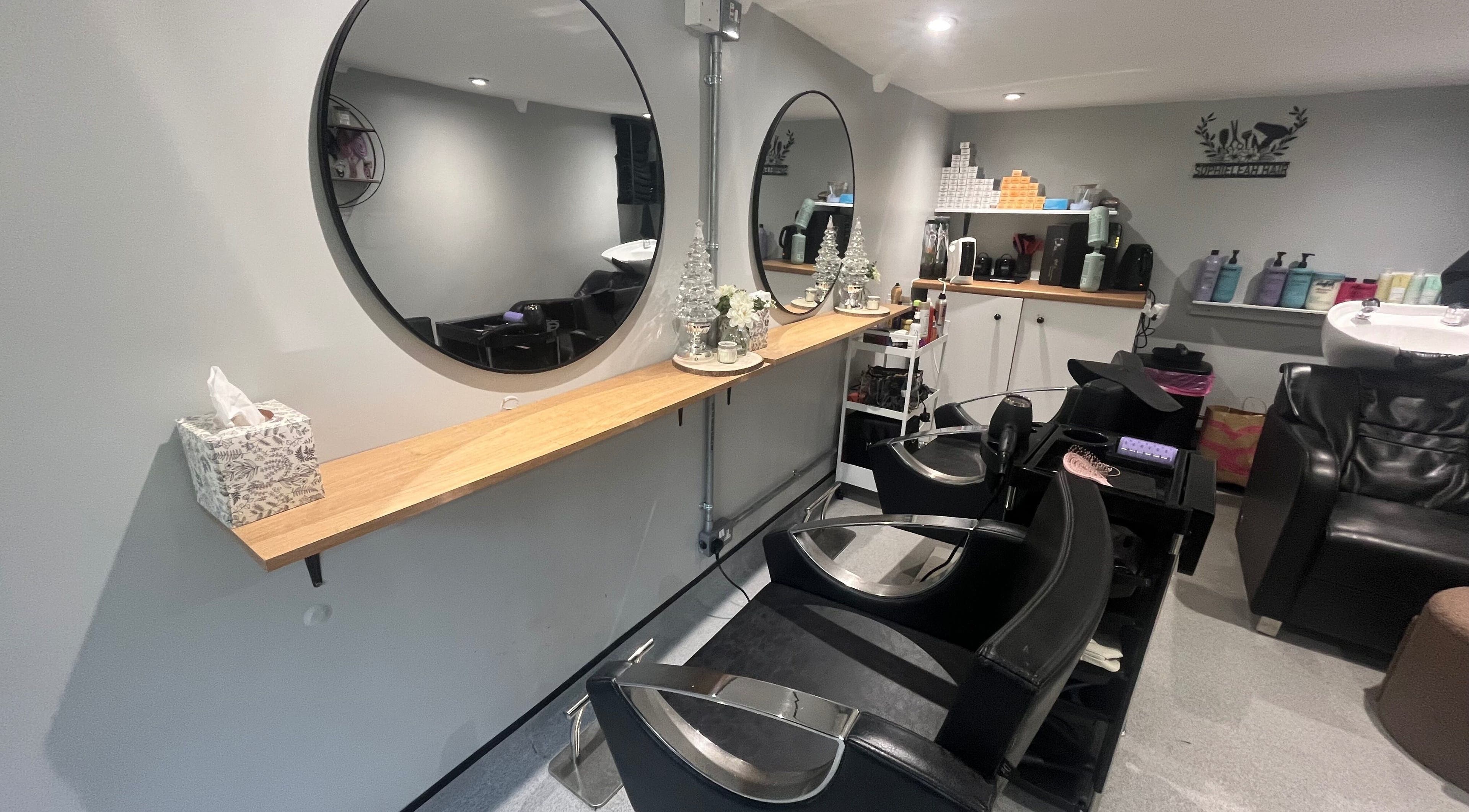 Elegant salon interior at Hair By Sophie Leah in Fifield, England, GB featuring stylish mirrors and seating.