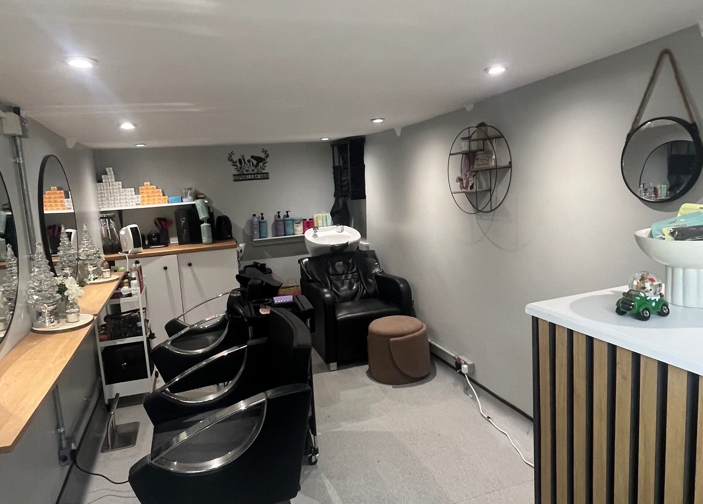 Contemporary salon interior of Hair By Sophie Leah, Fifield, England, GB, featuring stylish chairs and decor.