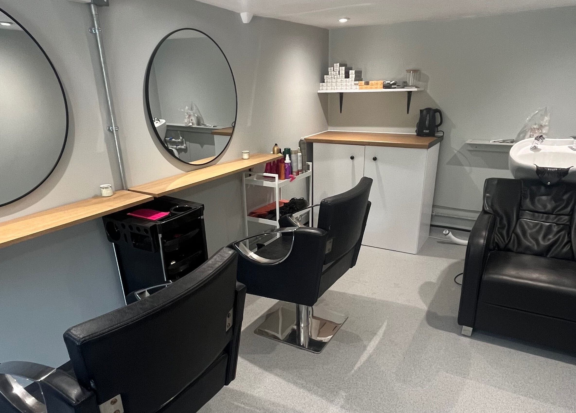 Modern salon interior at Hair By Sophie Leah, Fifield, England, GB, featuring stylish chairs and mirrors.