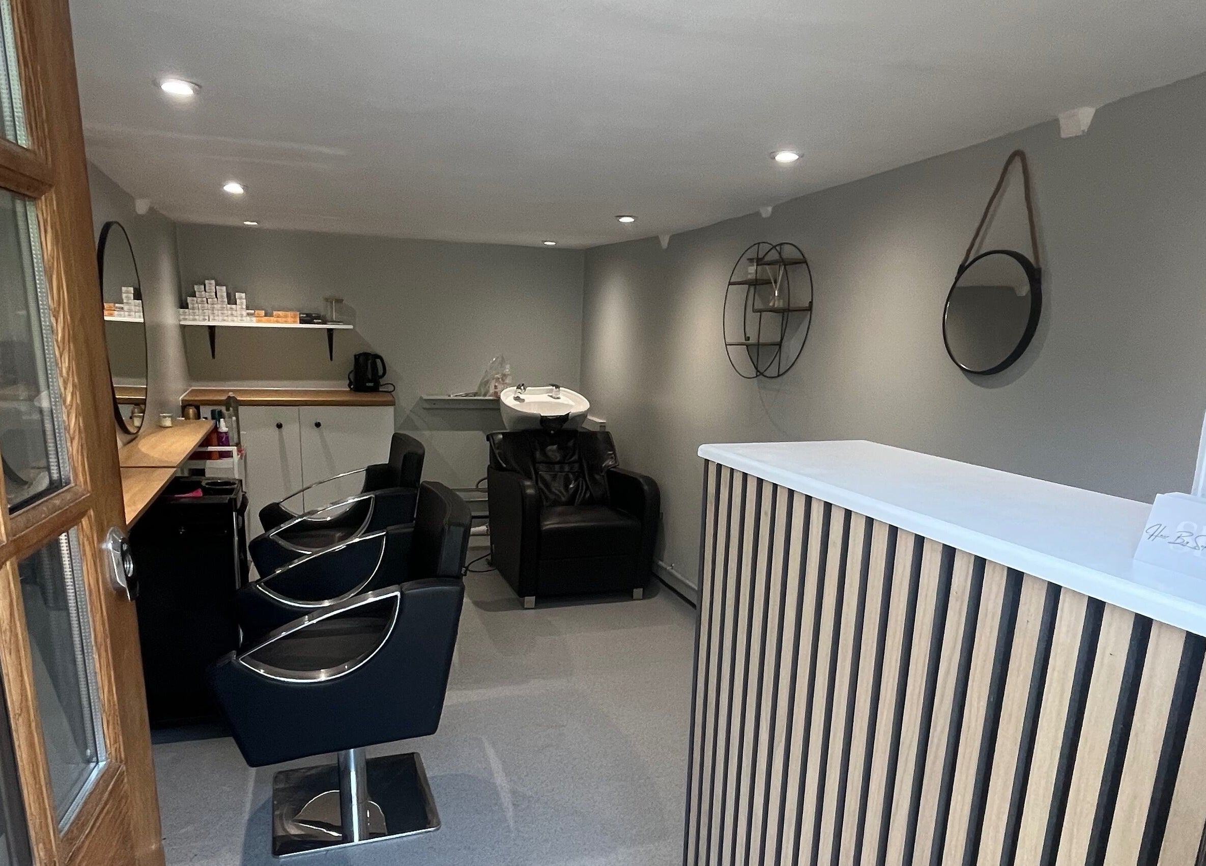 Compact, stylish interior of Hair By Sophie Leah salon in Fifield, England, GB showcasing modern styling chairs.