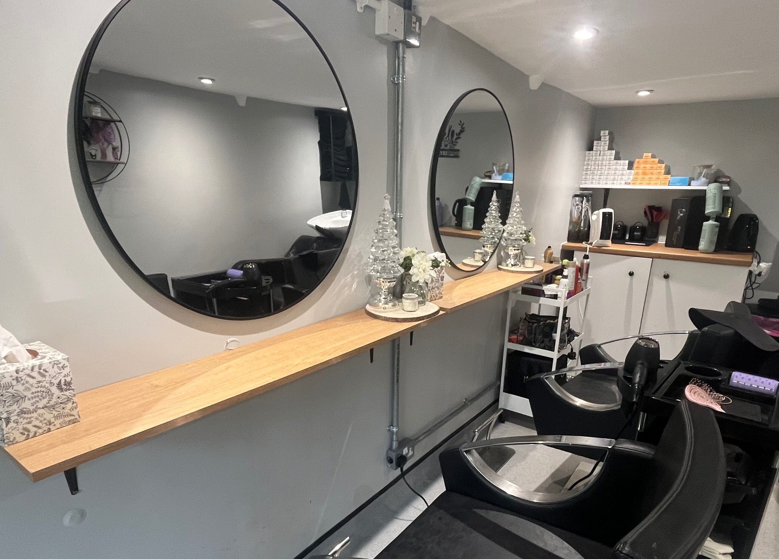Modern styling chairs and circular mirrors at Hair By Sophie Leah, Fifield, England, GB.