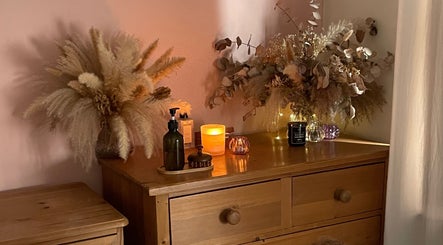 Elegant dresser with candles and foliage at Flow.S.Beauty Studio, Ash Vale, England, GB, creating a cozy atmosphere.