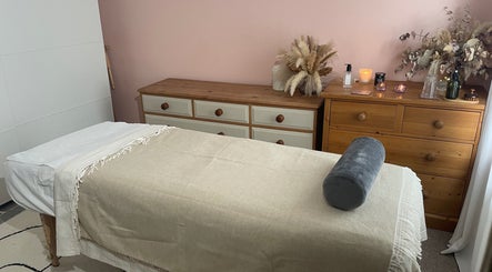 Tranquil massage room at Flow.S.Beauty Studio, Ash Vale, England, GB featuring a cozy massage table.