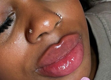 Close-up of glossy lips and elegant piercings at Milèro Aesthetics, Sheffield, England, GB.