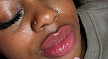 Close-up of glossy lips and elegant piercings at Milèro Aesthetics, Sheffield, England, GB.