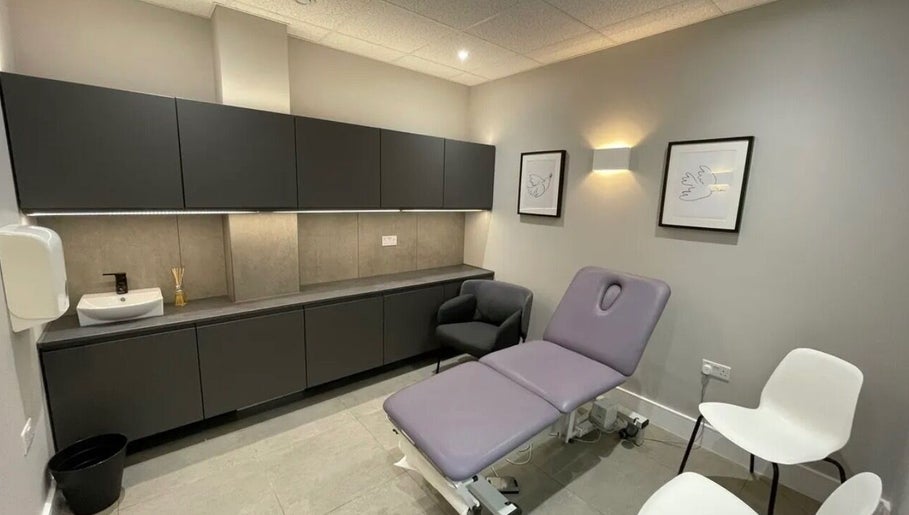 Modern treatment room at Aesthetics by Katrina in London, England, GB, featuring a plush treatment bed and seating.