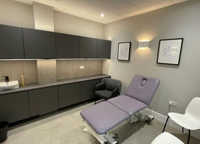 Modern treatment room at Aesthetics by Katrina in London, England, GB, featuring a plush treatment bed and seating.