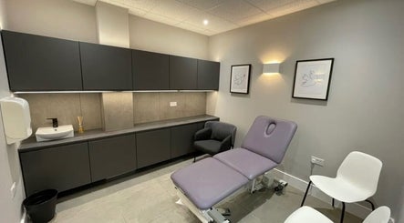 Modern treatment room at Aesthetics by Katrina in London, England, GB, featuring a plush treatment bed and seating.