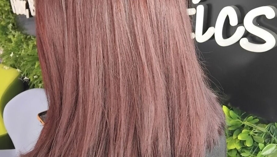 Close-up of rosy pink hair at Emma Hair, Liverpool, England, GB, showcasing vibrant color and smooth texture.