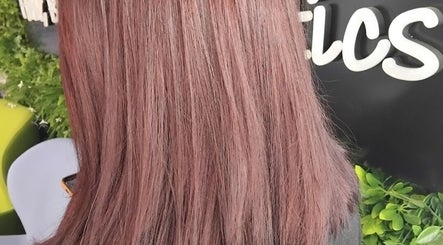 Close-up of rosy pink hair at Emma Hair, Liverpool, England, GB, showcasing vibrant color and smooth texture.