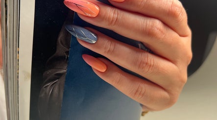 Hand showcasing vibrant nail art at Nails by Ilona, Chicago, United States, US. Metallic accents enhance the design.