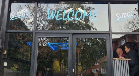 Welcome sign at DŌMN THERAPY in Liverpool, England, GB, with reflective glass entrance.