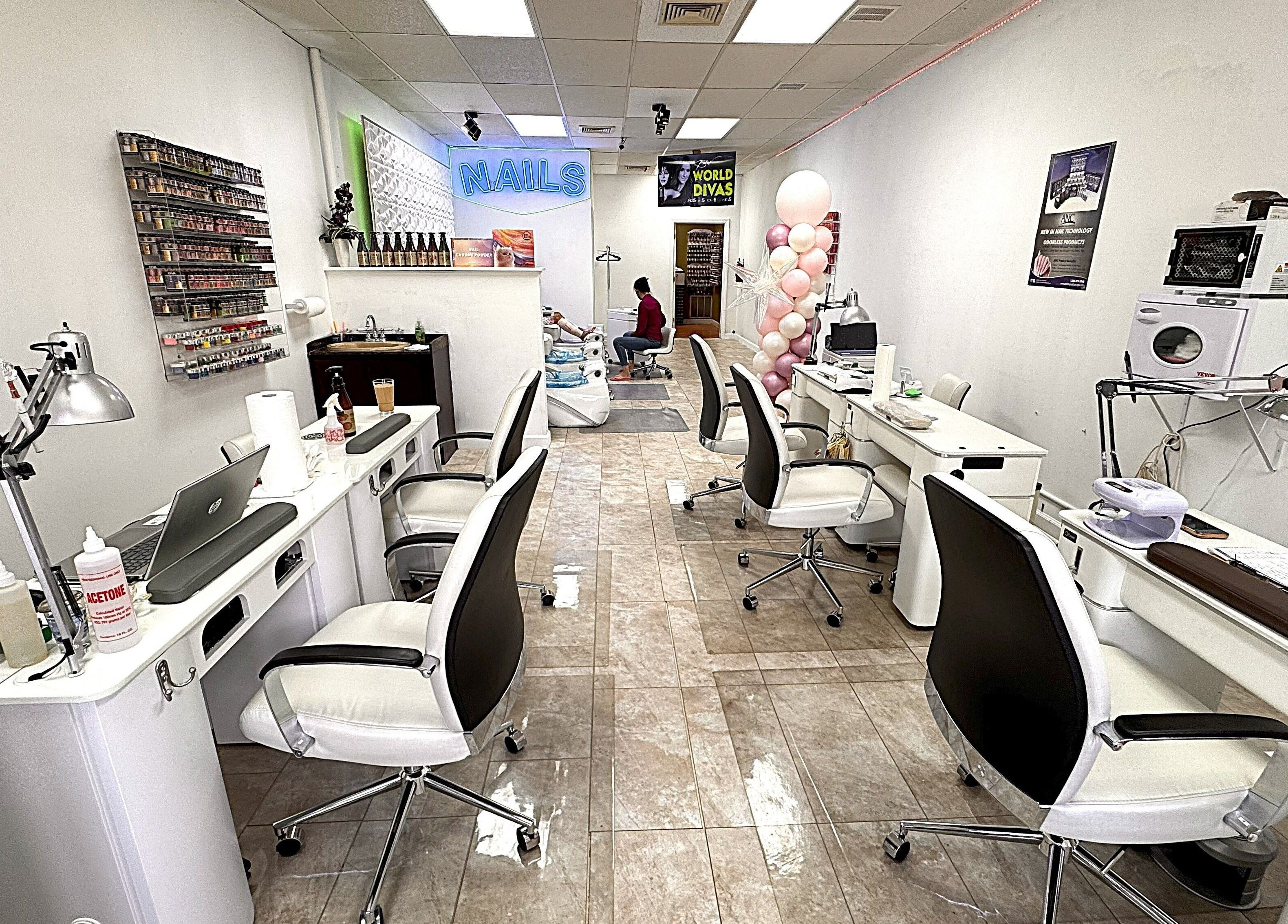 Spacious interior of New Tek Nails in Manchester Township, New Jersey, US showcasing nail stations and décor.