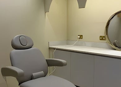 Modern treatment chair and mirror at Clinic E, Clarkston, Scotland, GB. Sleek and professional beauty setting.