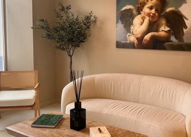 Elegant lounge at Clinic E in Clarkston, Scotland featuring cozy seating and artwork.