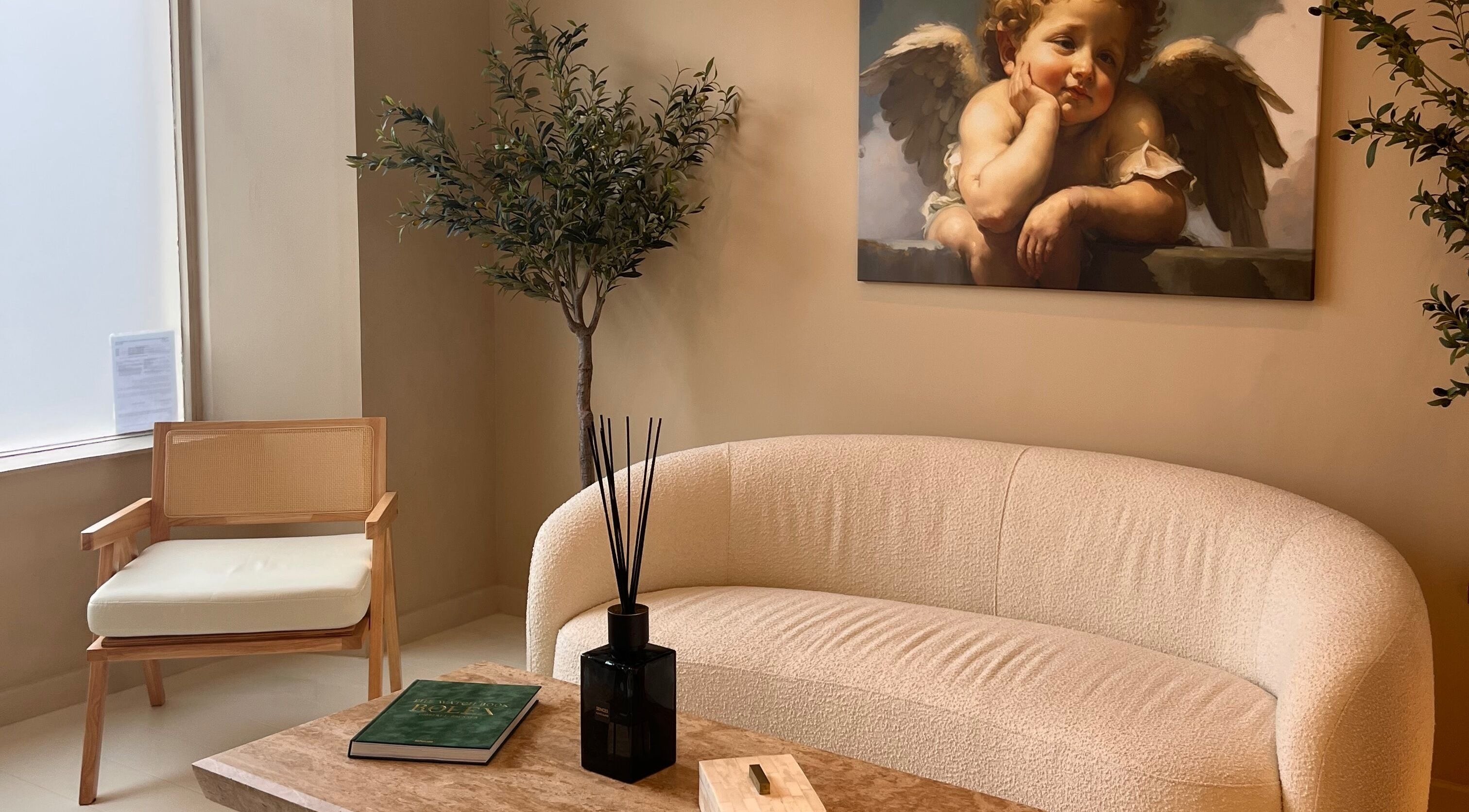 Elegant lounge at Clinic E in Clarkston, Scotland featuring cozy seating and artwork.