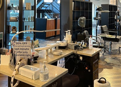 Interior of DZVINKA Beauty Studio in Edmonton, Alberta, CA showcasing modern styling stations and products.