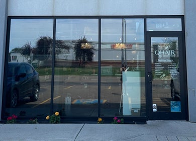 Front entrance of DZVINKA Beauty Studio in Edmonton, Alberta, CA with modern glass facade.