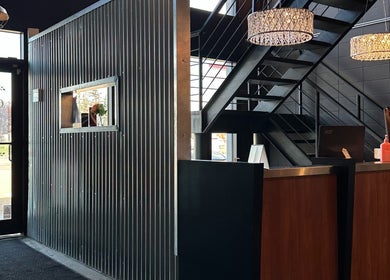 Industrial-chic entrance of DZVINKA Beauty Studio in Edmonton, Alberta, CA with modern decor and reception area.
