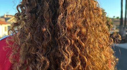 Close-up of sunlit curly hair styled at Hevani Touch, Riverside, California, US.