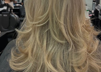 Blonde wavy hairstyle service at Hevani Touch, Riverside, California, US showcasing luxurious salon results.