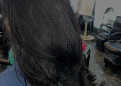 Sleek black hair styled at Hevani Touch in Riverside, California, US. Modern salon vibe.