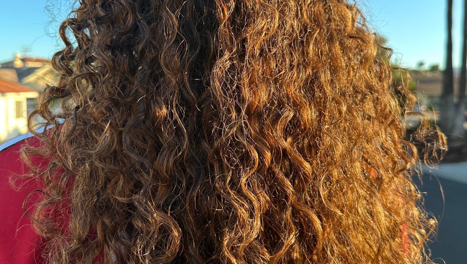 Vibrant curls glistening in the sun at Hevani Touch, Riverside, California, US.