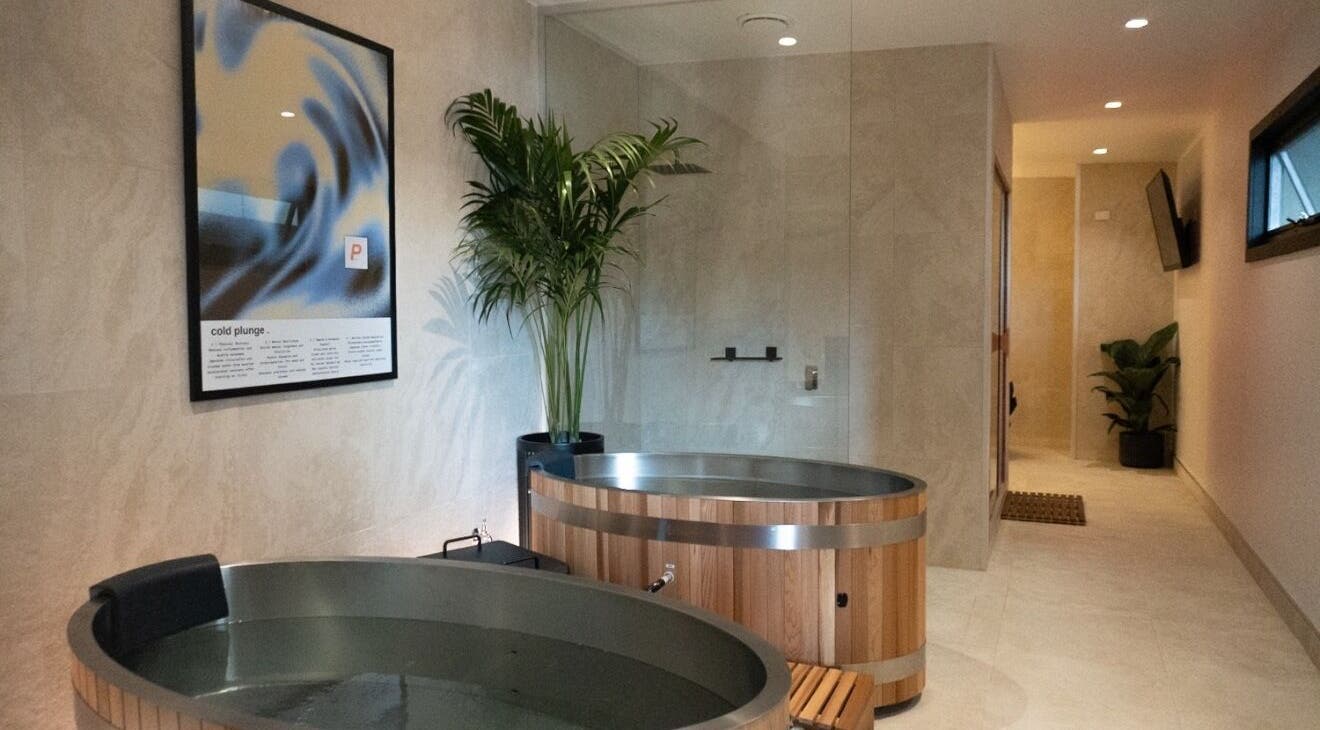 Modern cold plunge room at Paced Recovery in Melbourne, Victoria, AU with wooden tubs and serene decor.
