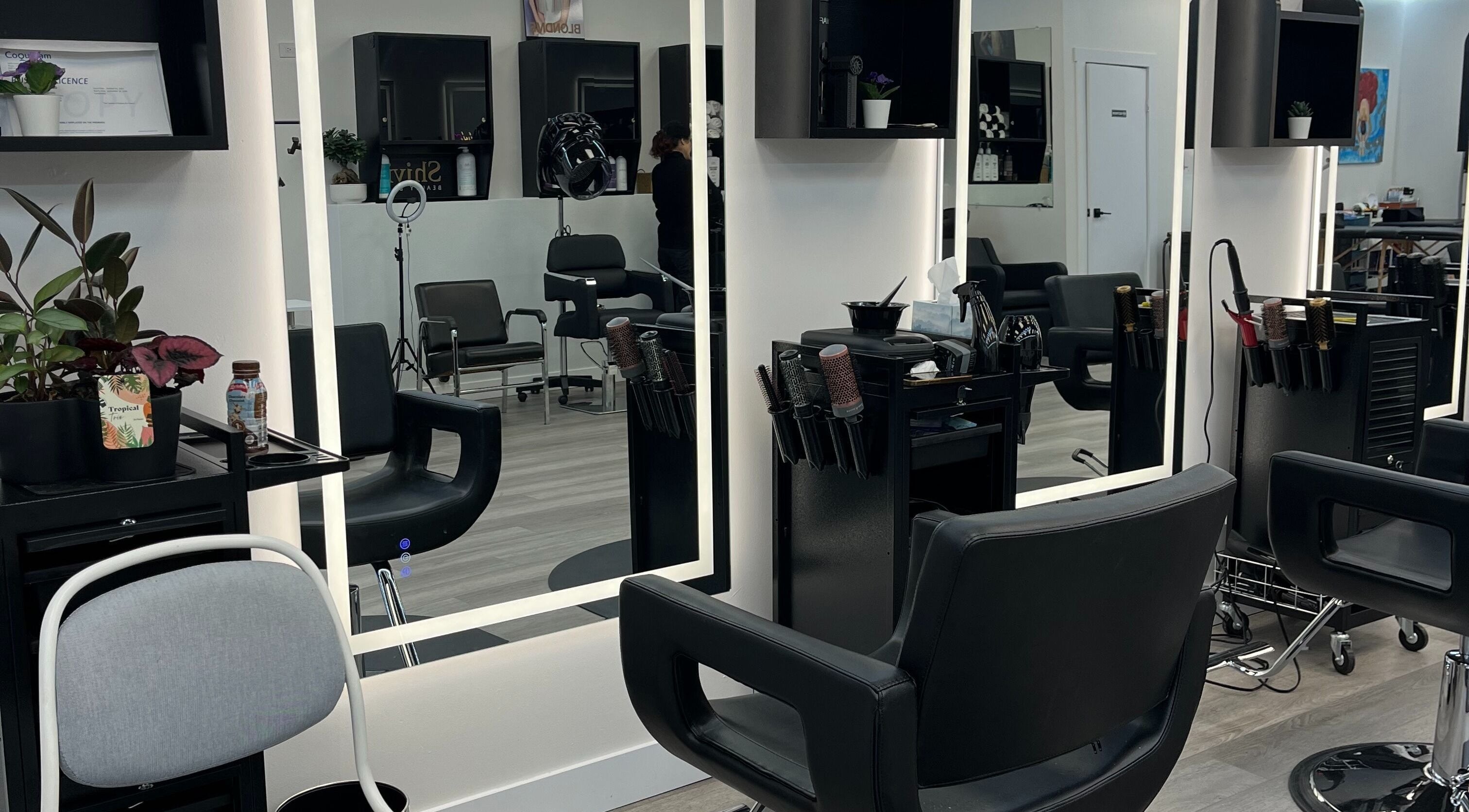 Modern salon interior at Sungho Hair Salon, Coquitlam, British Columbia, CA with stylish chairs and mirrors.