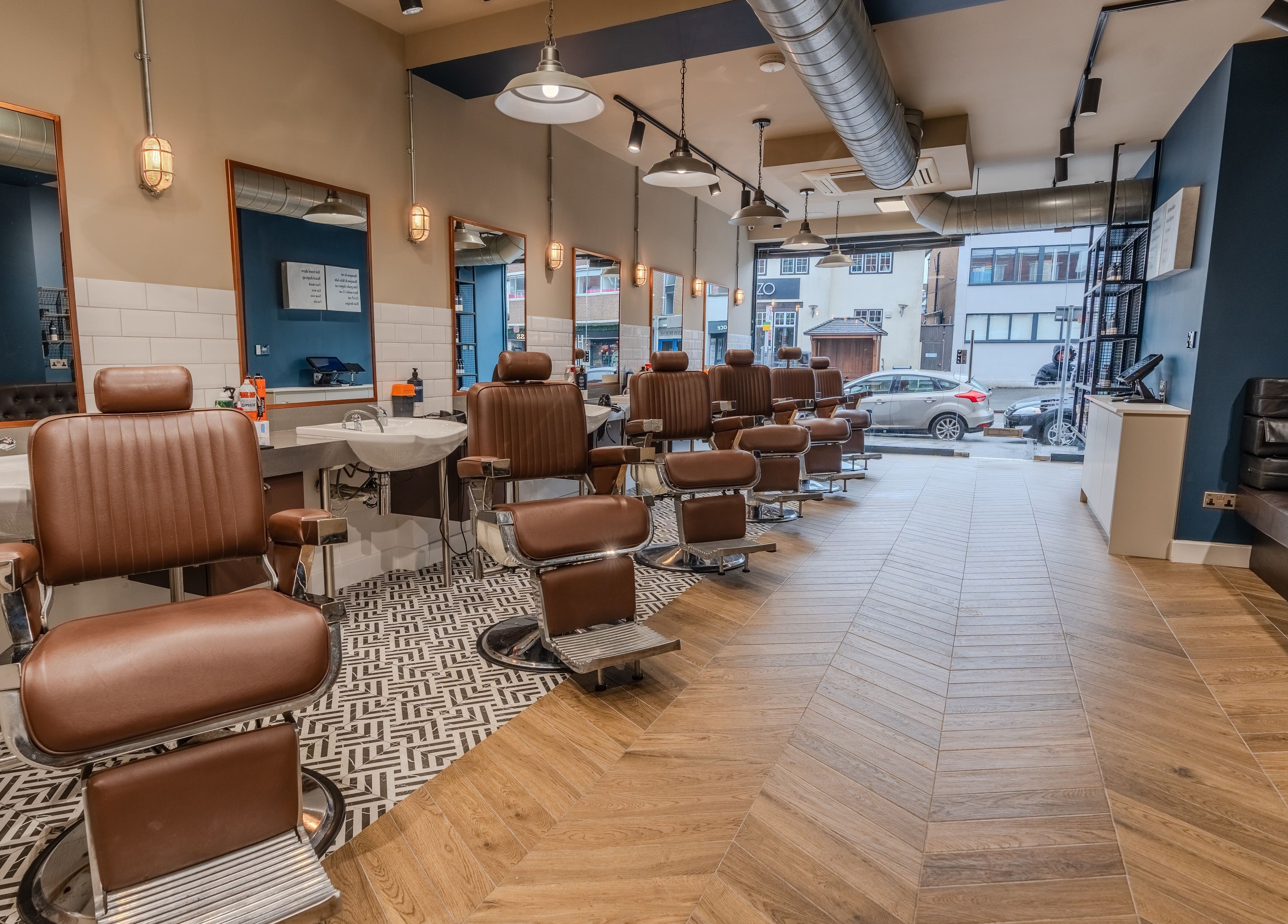 Vintage barber chairs at Sammies Studio - Banstead, England, GB, showcasing modern elegance and comfort.