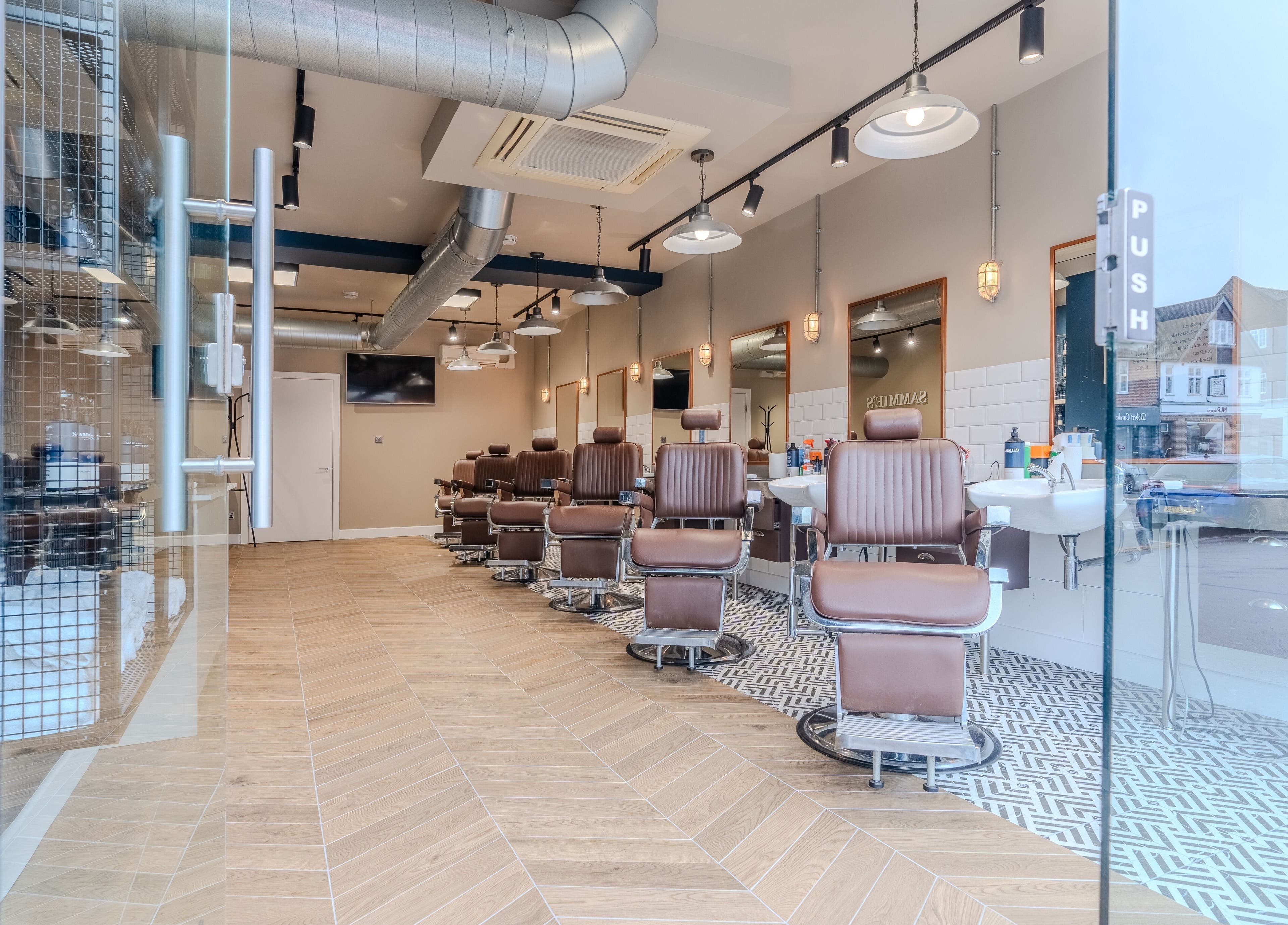 Elegant interior of Sammies Studio - Banstead, showcasing modern barber chairs, located in Banstead, England, GB.