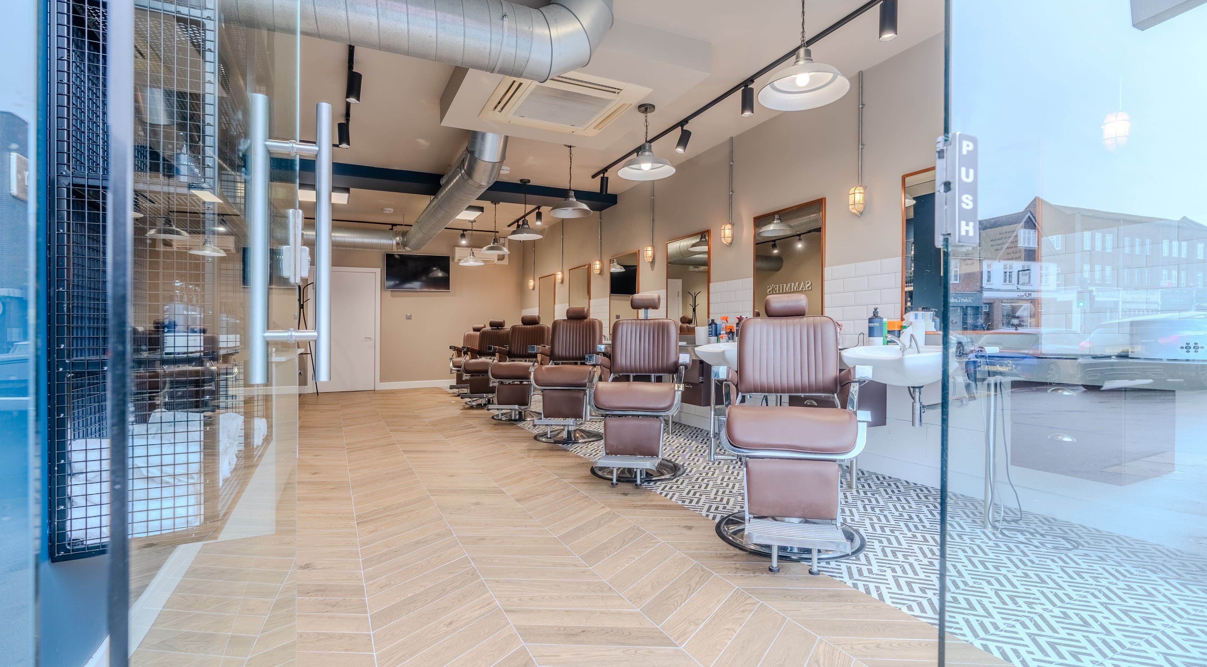 Elegant interior of Sammies Studio - Banstead, showcasing modern barber chairs, located in Banstead, England, GB.