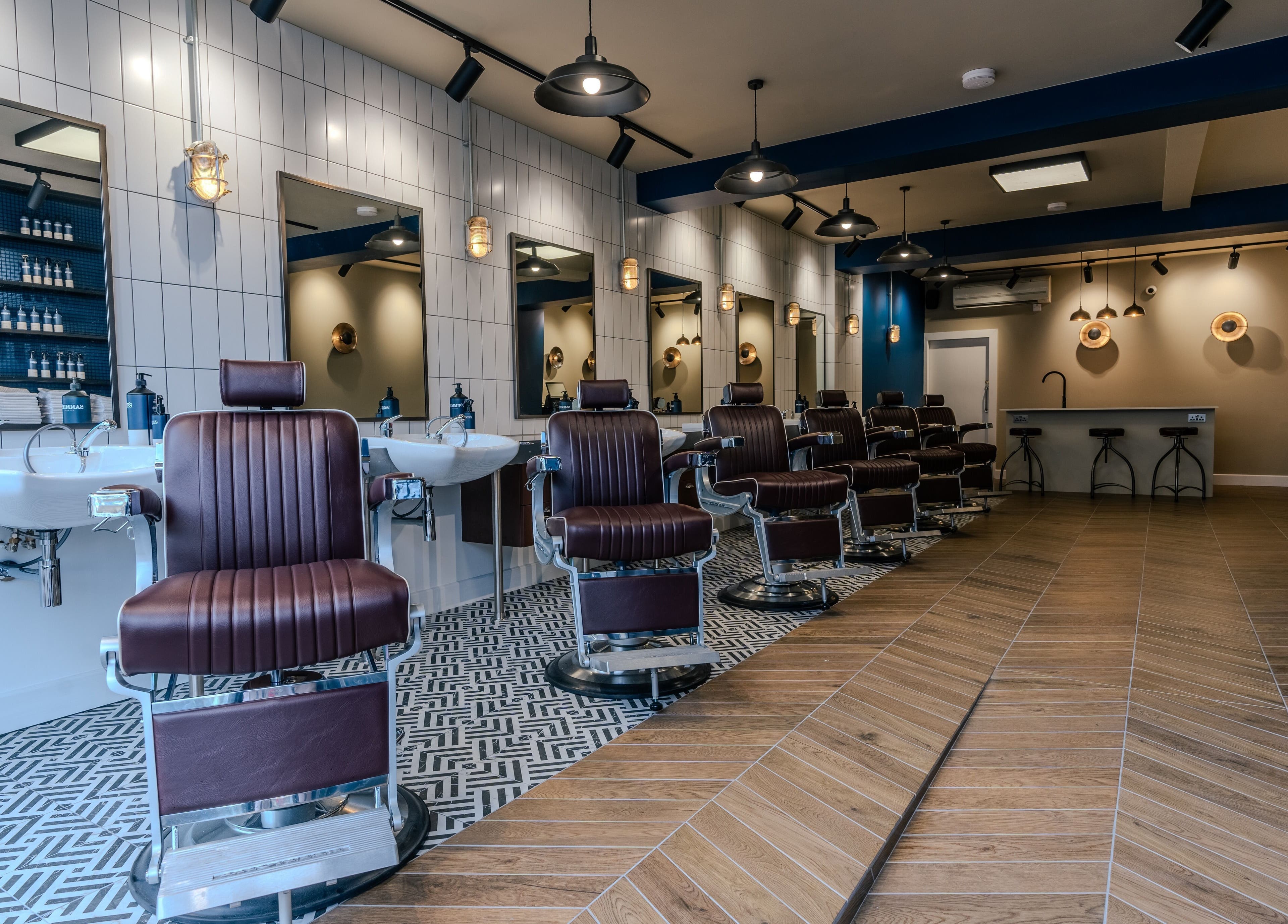 Modern barber chairs at Sammies Studio - Northcote Road, London, England, GB, showcasing a stylish interior.