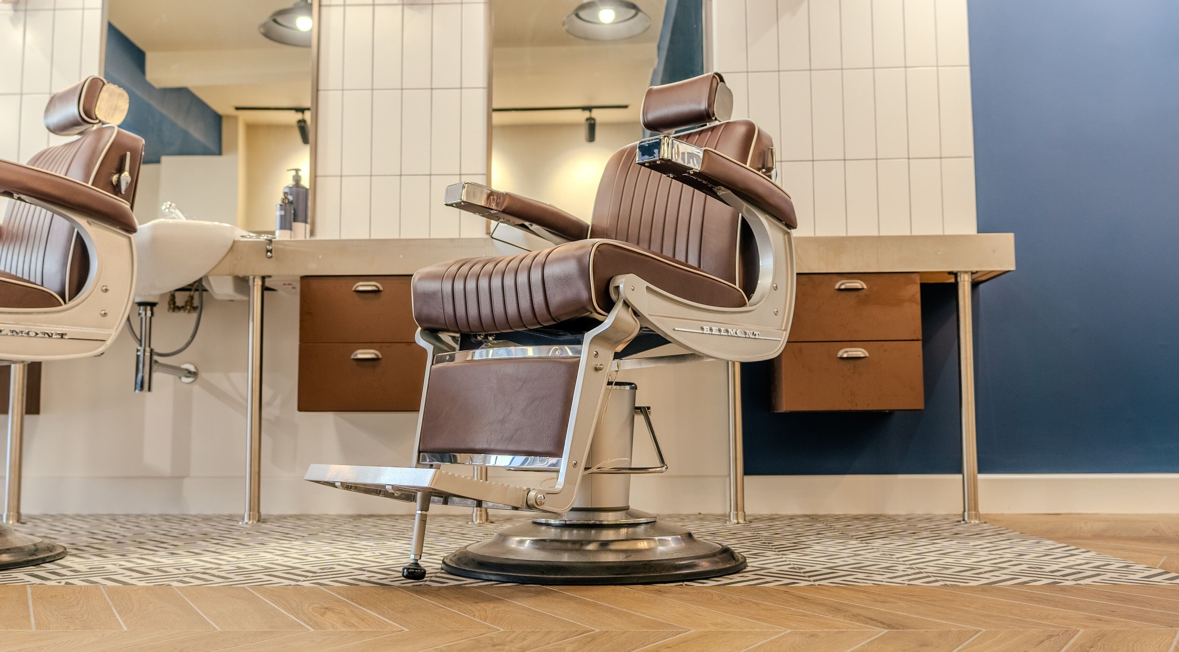 Elegant barber chair at Sammies Studio - Northcote Road, London, England, GB. Modern decor enhances vintage charm.