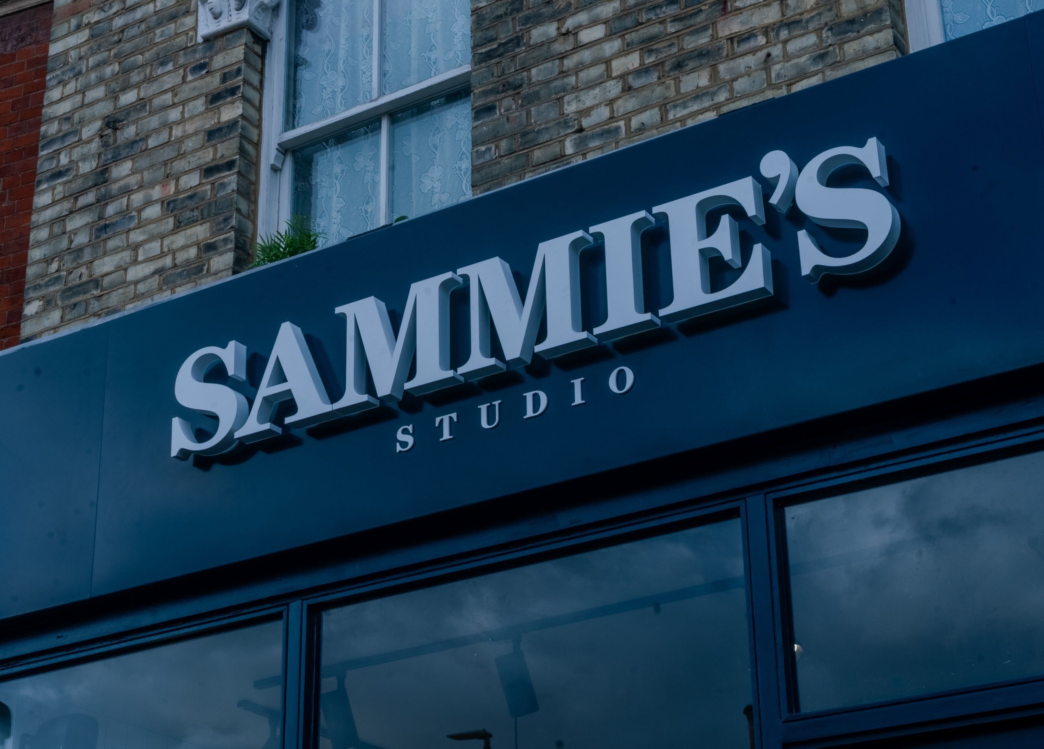 Exterior facade of Sammies Studio - Northcote Road, London, England, GB with elegant signage.