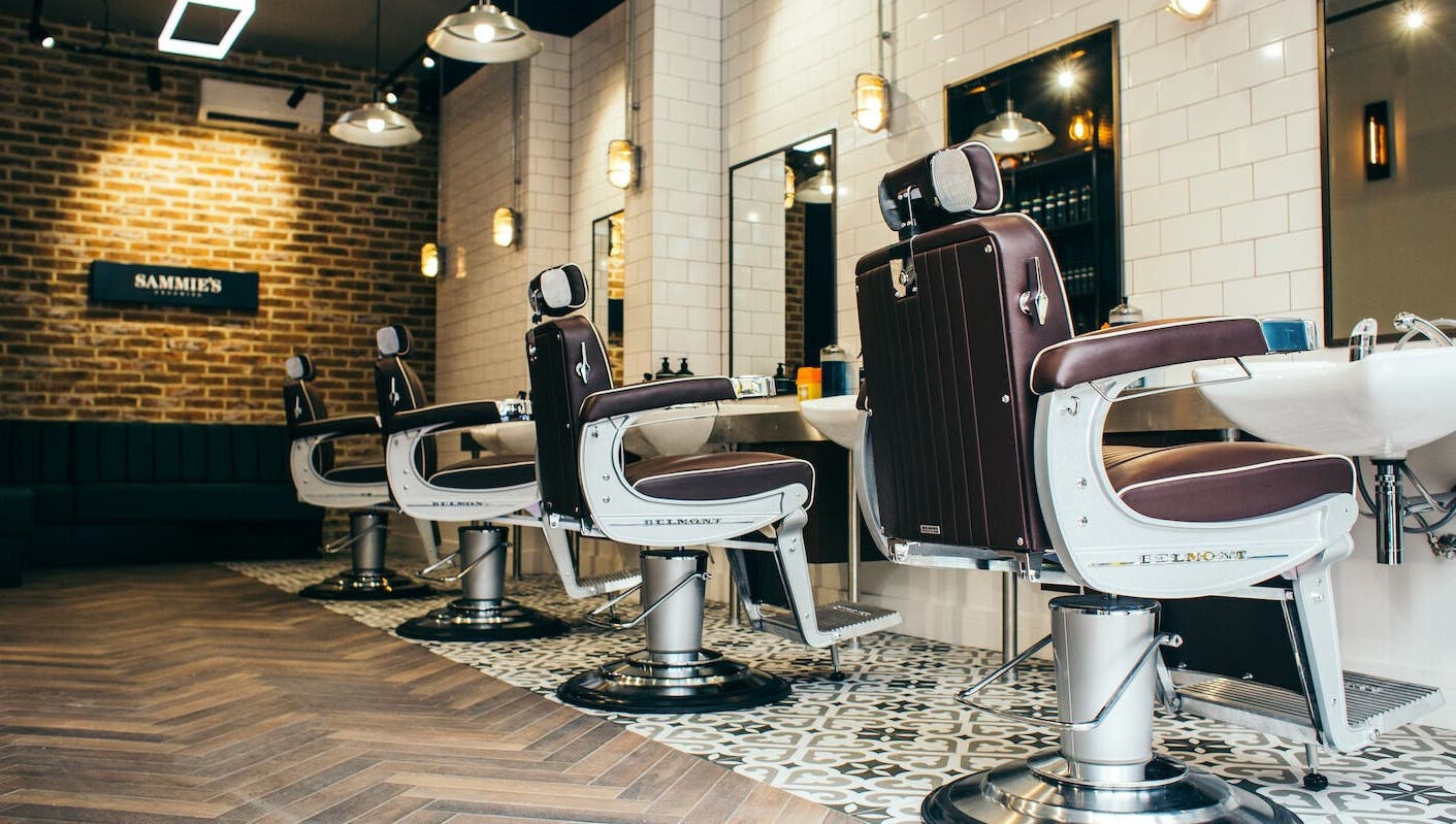 Elegant barber chairs at Sammies Studio - Fulham Road, London, England, GB showcasing modern design.